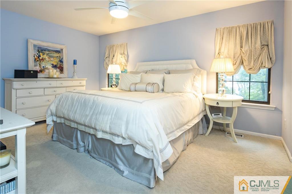 205 Timber Oaks Road, Unit 205 Edison, NJ 08820 - Photo 21 of 31 a bedroom with a bed and a table in it