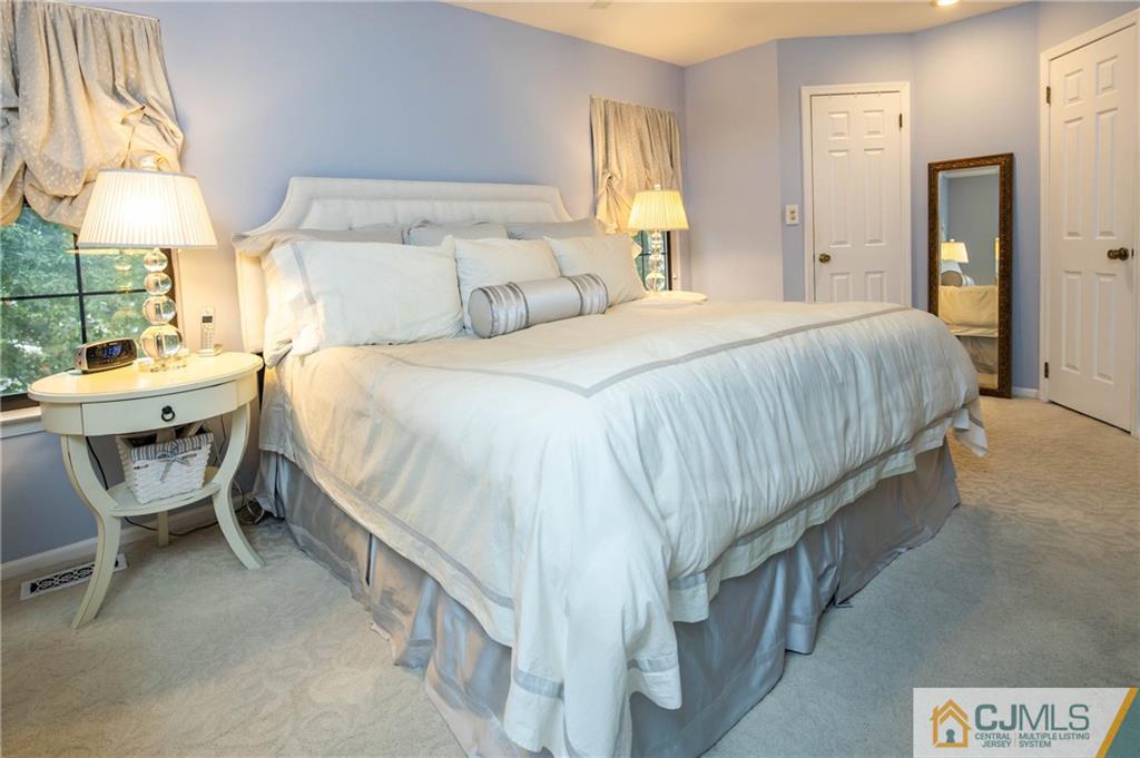 205 Timber Oaks Road, Unit 205 Edison, NJ 08820 - Photo 22 of 31 a bedroom with a bed and a lamp