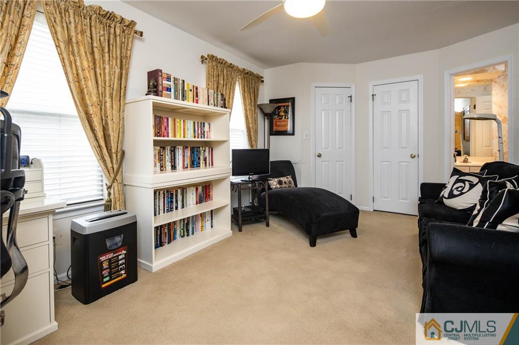205 Timber Oaks Road, Unit 205 Edison, NJ 08820 - Photo 24 of 31 a bedroom with a bed a book shelf and a window