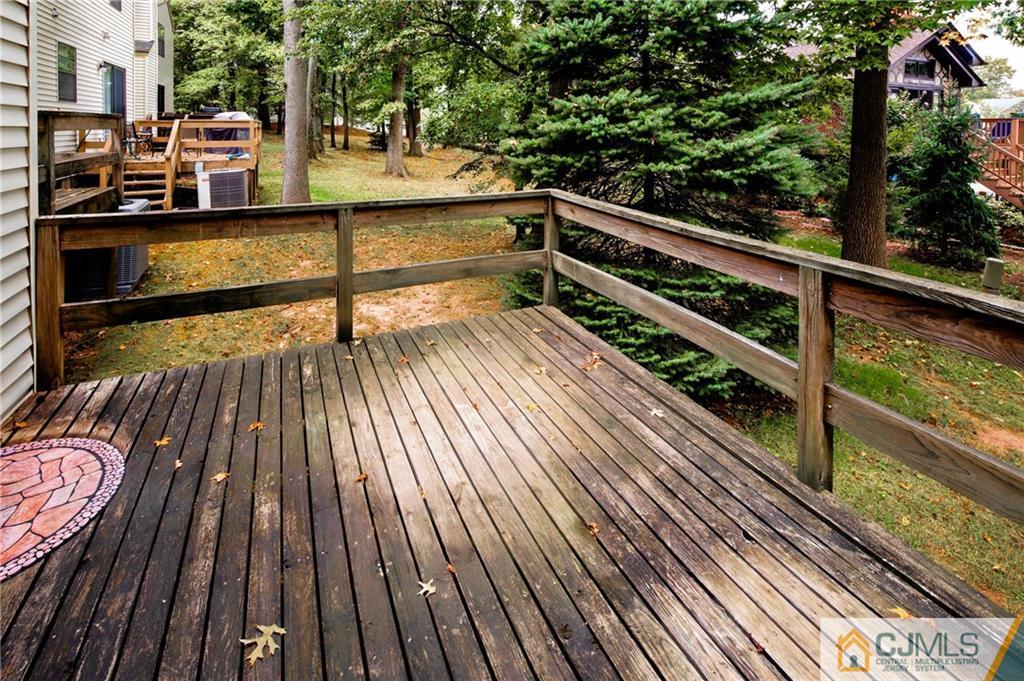 205 Timber Oaks Road, Unit 205 Edison, NJ 08820 - Photo 27 of 31 a view of balcony with wooden floor and fence