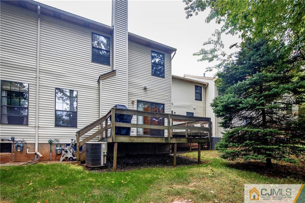 205 Timber Oaks Road, Unit 205 Edison, NJ 08820 - Photo 28 of 31 a view of a wooden chairs and a table chair in front of a house