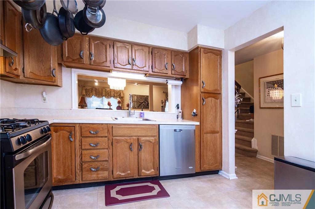 205 Timber Oaks Road, Unit 205 Edison, NJ 08820 - Photo 7 of 31 a kitchen with stainless steel appliances granite countertop a stove a sink dishwasher and cabinets with wooden floor