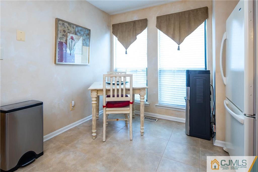 205 Timber Oaks Road, Unit 205 Edison, NJ 08820 - Photo 9 of 31 a dining room with furniture and a window