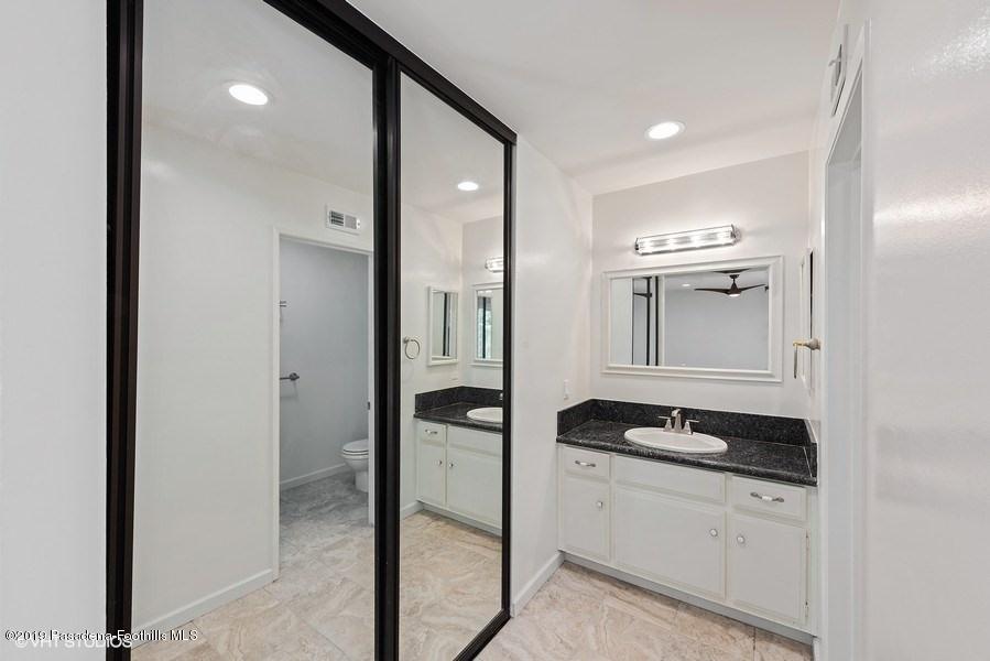 421 Cloverleaf Drive Monrovia, CA 91016 - Photo 14 of 21 a bathroom with a granite countertop sink a vanity and a mirror