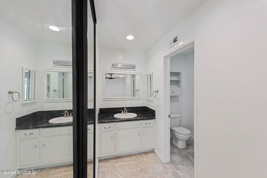 421 Cloverleaf Drive Monrovia, CA 91016 - Photo 15 of 21 a bathroom with a granite countertop sink and a mirror