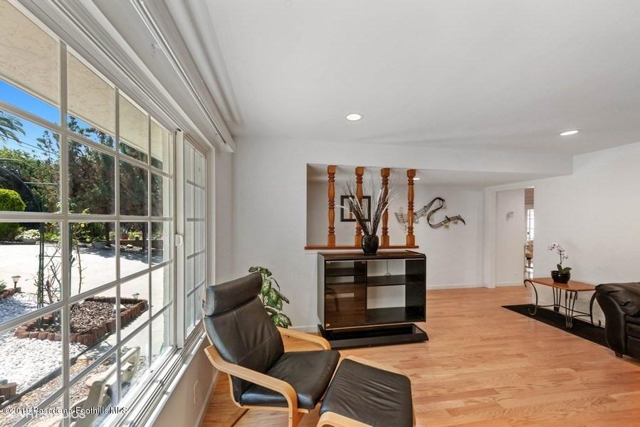 421 Cloverleaf Drive Monrovia, CA 91016 - Photo 3 of 21 a living room with furniture a flat screen tv and a floor to ceiling window