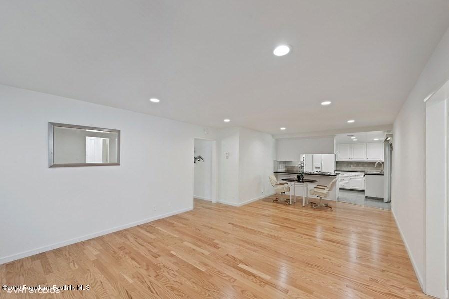 421 Cloverleaf Drive Monrovia, CA 91016 - Photo 5 of 21 a view of a kitchen with kitchen island stainless steel appliances wooden floor dining table and chairs