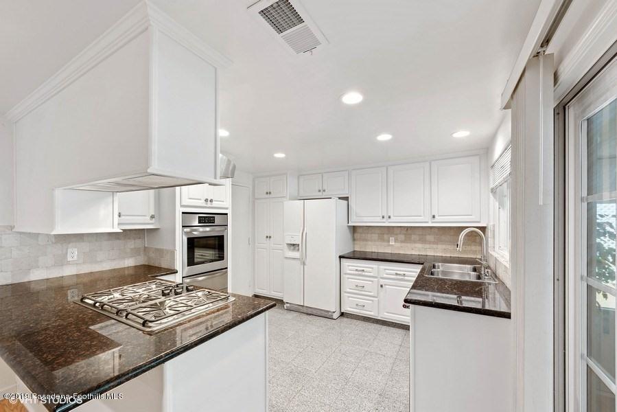 421 Cloverleaf Drive Monrovia, CA 91016 - Photo 8 of 21 a kitchen with stainless steel appliances granite countertop a stove refrigerator sink and cabinets