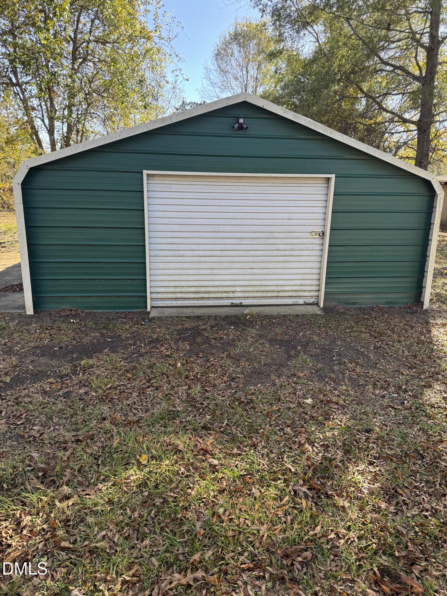 11993 Rockside Road Middlesex, NC 27557 - Photo 14 of 15 a small white house with a yard and garage