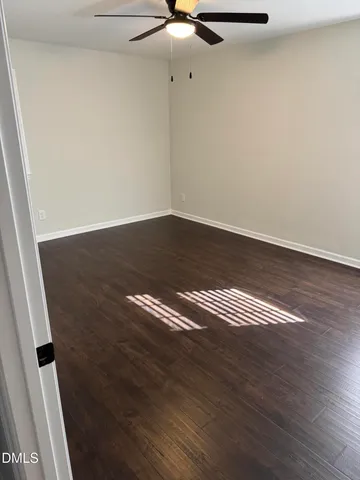 a view of room with wooden floor