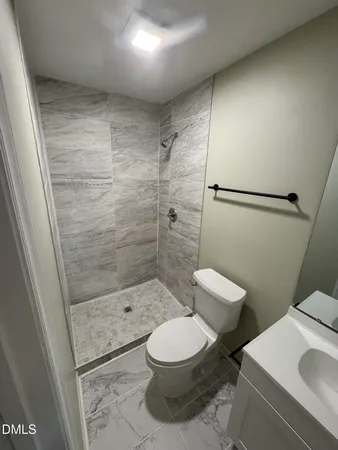 a bathroom with a toilet and a shower