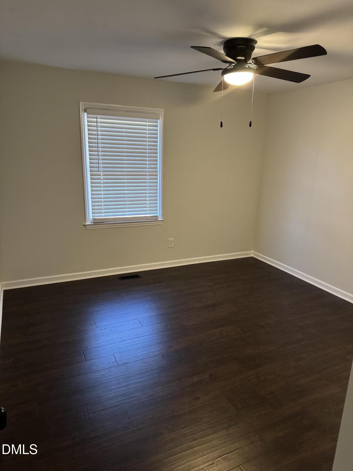 11993 Rockside Road Middlesex, NC 27557 - Photo 7 of 15 a view of an empty room with wooden floor