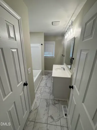 a bathroom with a sink a mirror and a shower