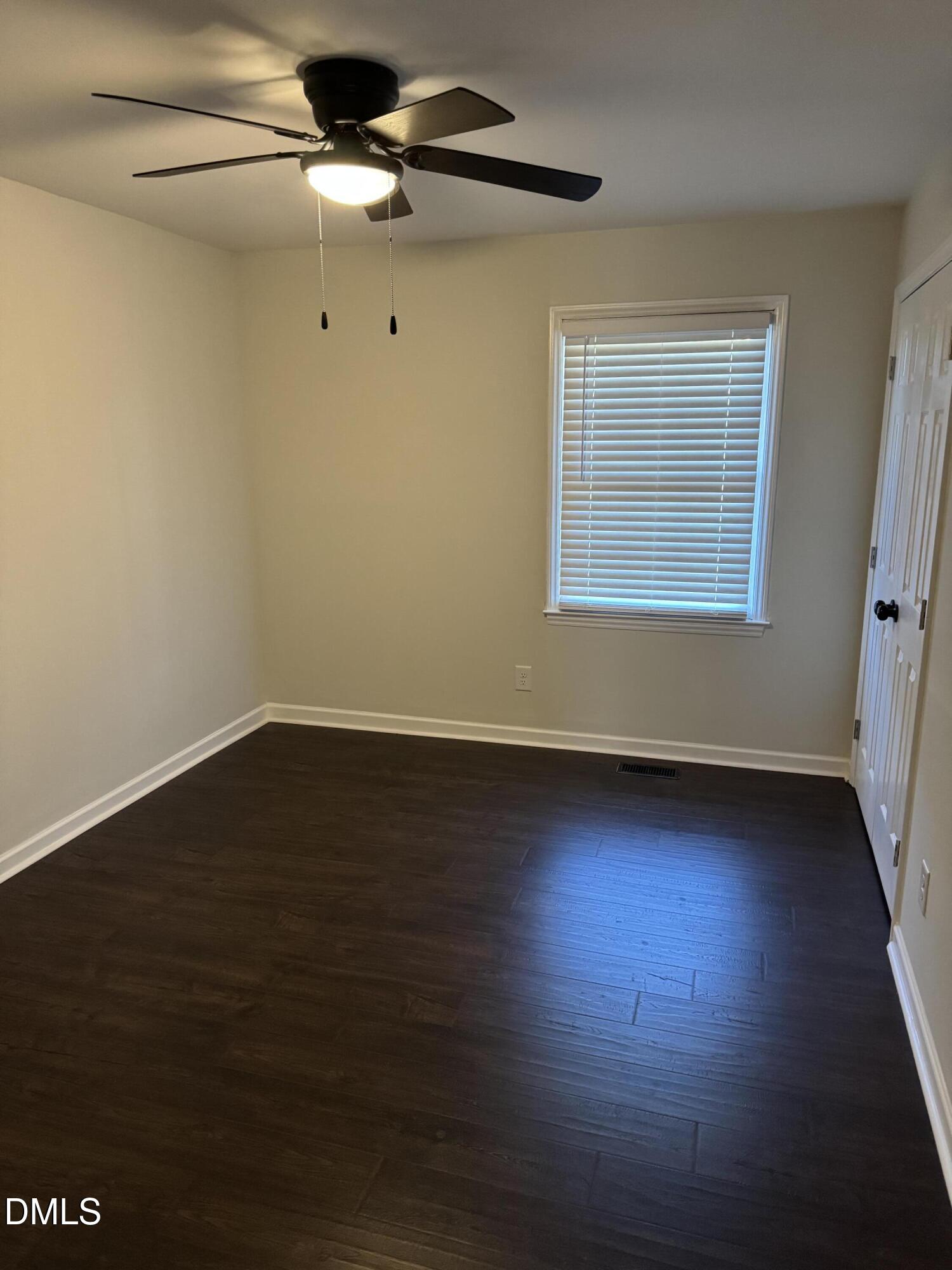 11993 Rockside Road Middlesex, NC 27557 - Photo 10 of 15 a view of an empty room with wooden floor and a window