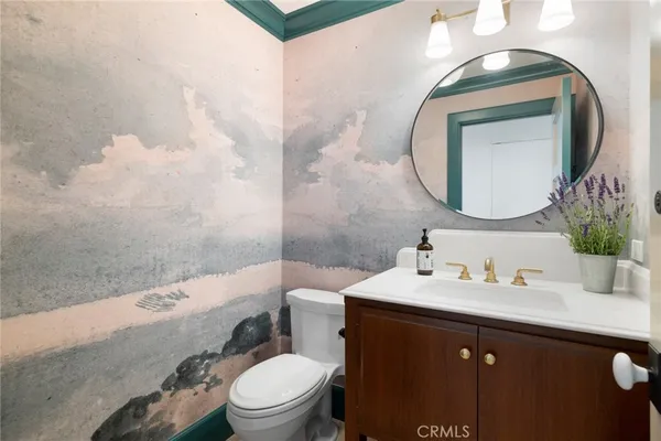 a bathroom with a sink a toilet and mirror