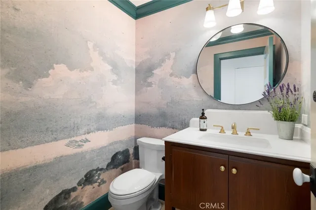 a bathroom with a sink a toilet and mirror