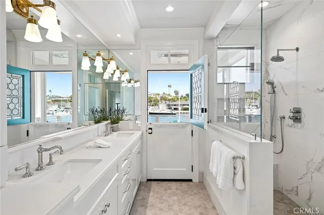 a spacious bathroom with a double vanity sink a mirror and shower