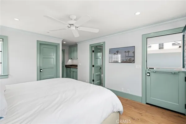 a bedroom with a large bed and a chandelier