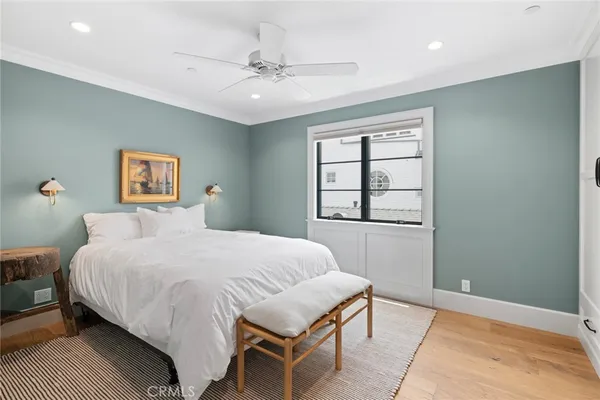 a bedroom with a large bed and a window