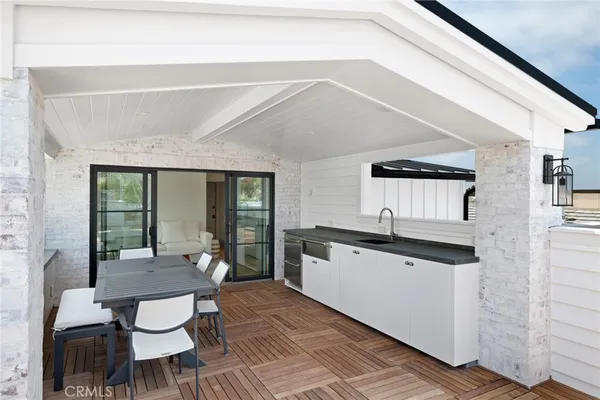 a living room with granite countertop furniture a dining table and chairs with wooden floor