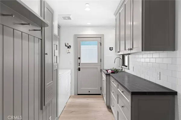 a kitchen with a sink and refrigerator