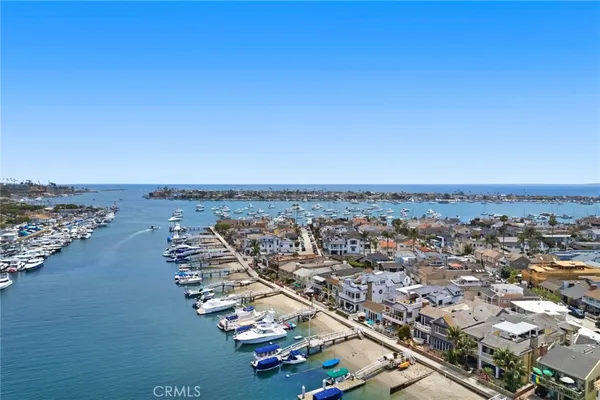 an aerial view of a city with ocean view in back
