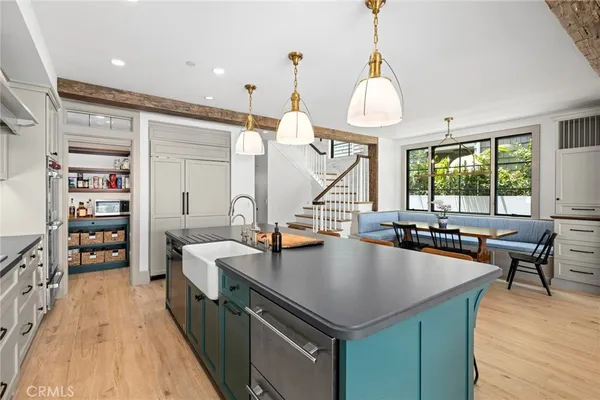 a kitchen with stainless steel appliances granite countertop a sink a stove and wooden floor