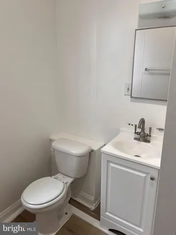 a white toilet sitting next to a bathroom sink