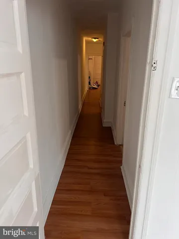 a view of a hallway with a white walls and stairs