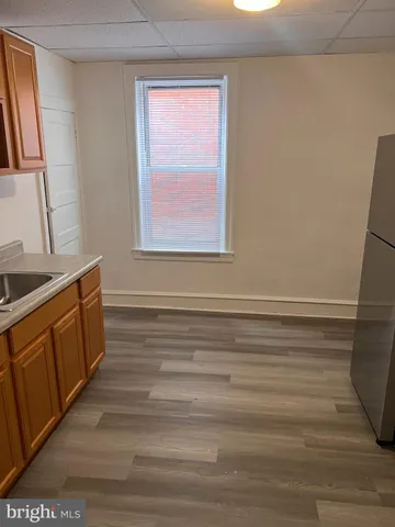 a view of a kitchen with wooden floor