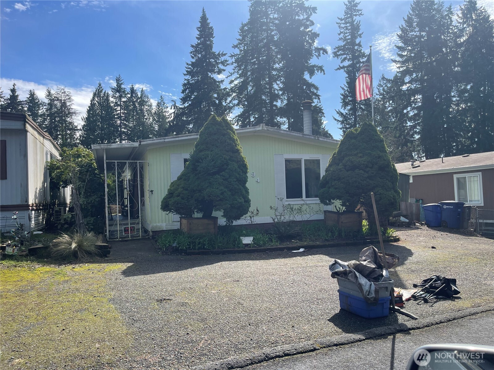 3333 228th Street Southeast, Unit 94 Bothell, WA 98021 - Photo 2 of 12 a front view of a house with a yard