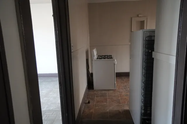 a view of a refrigerator in kitchen and utility room