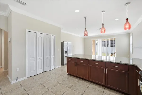 a kitchen with stainless steel appliances granite countertop a sink a stove and a refrigerator
