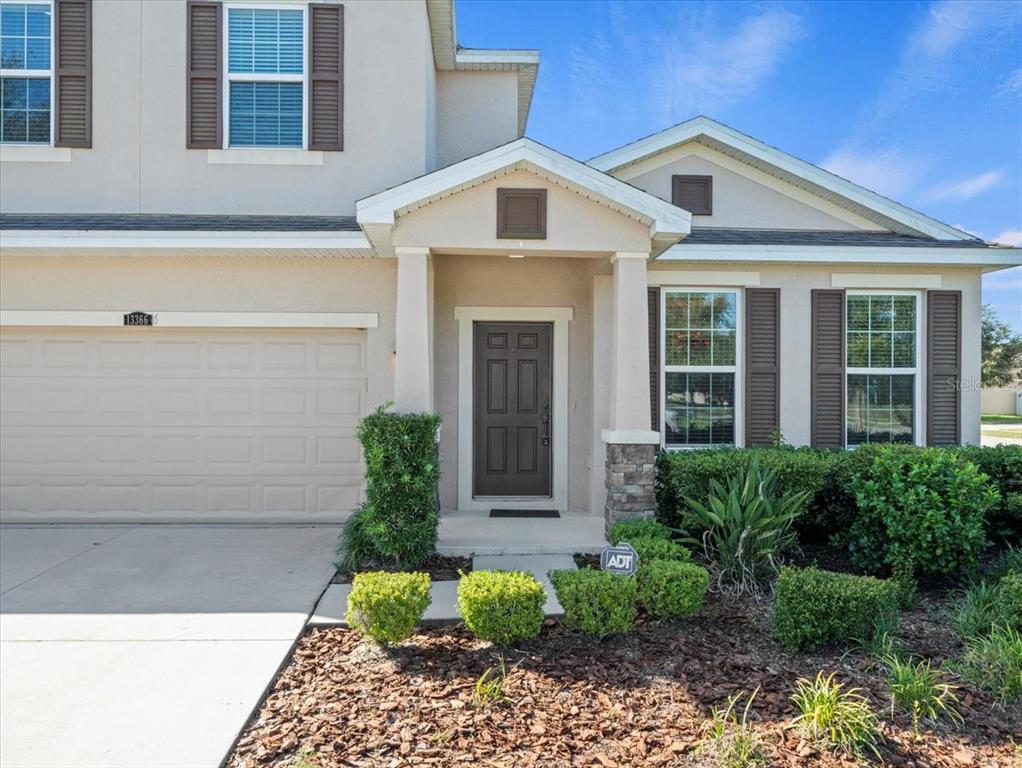 13366 Barkingside Place Spring Hill, FL 34609 - Photo 2 of 41 a front view of a house with garden
