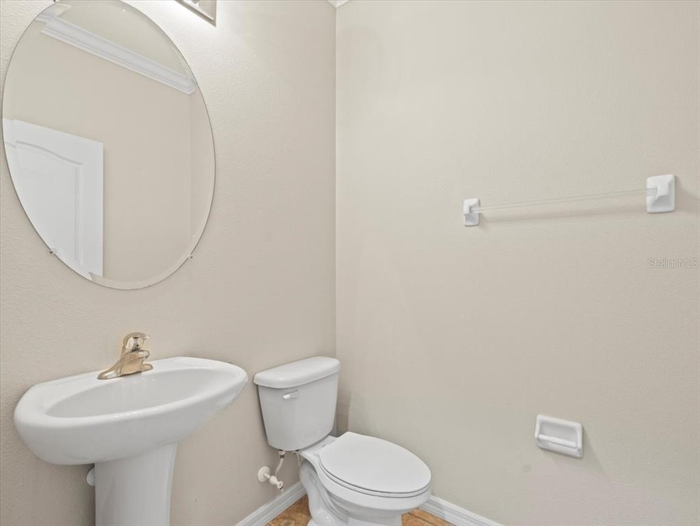 13366 Barkingside Place Spring Hill, FL 34609 - Photo 29 of 41 a bathroom with a sink a mirror and a toilet