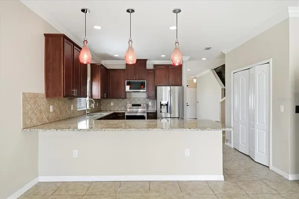a kitchen with stainless steel appliances granite countertop a refrigerator stove a sink and dishwasher
