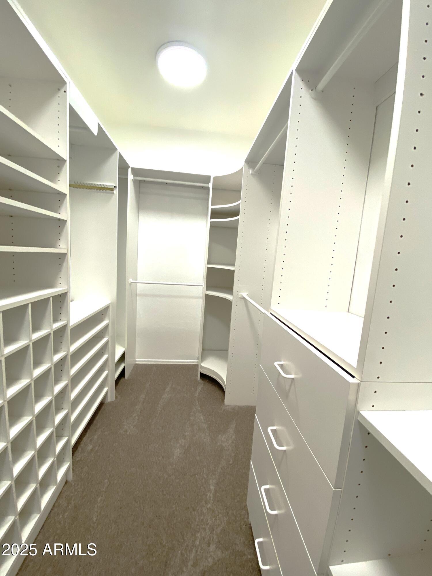 40320 North Exploration Trail Anthem, AZ 85086 - Photo 12 of 33 a view of an empty room with wooden floor and a window