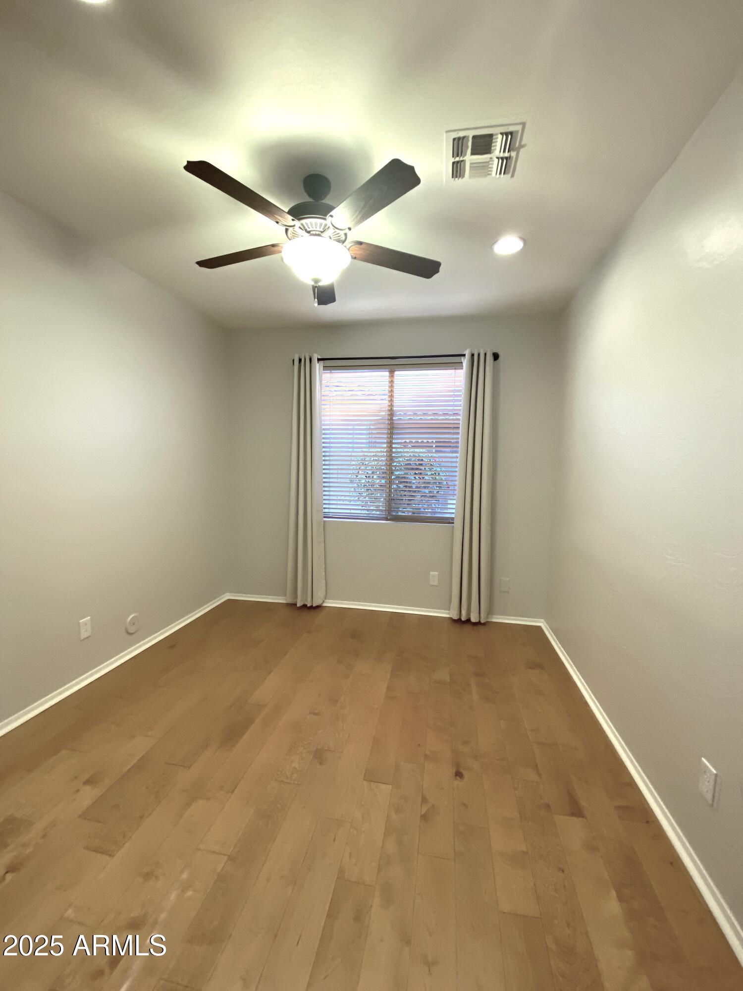 40320 North Exploration Trail Anthem, AZ 85086 - Photo 16 of 33 an empty room with windows and fan