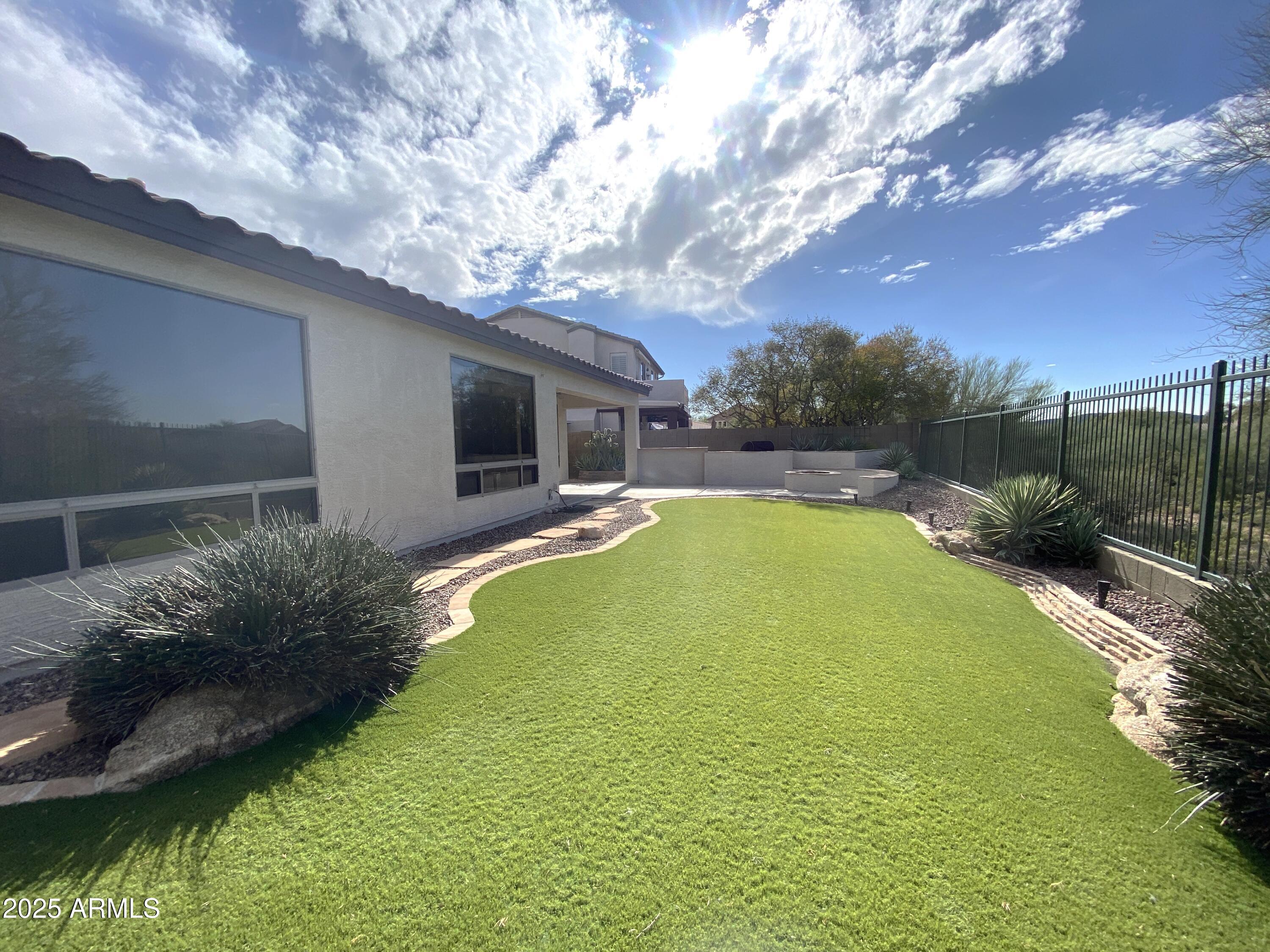 40320 North Exploration Trail Anthem, AZ 85086 - Photo 24 of 33 a view of a swimming pool with an outdoor space and seating area