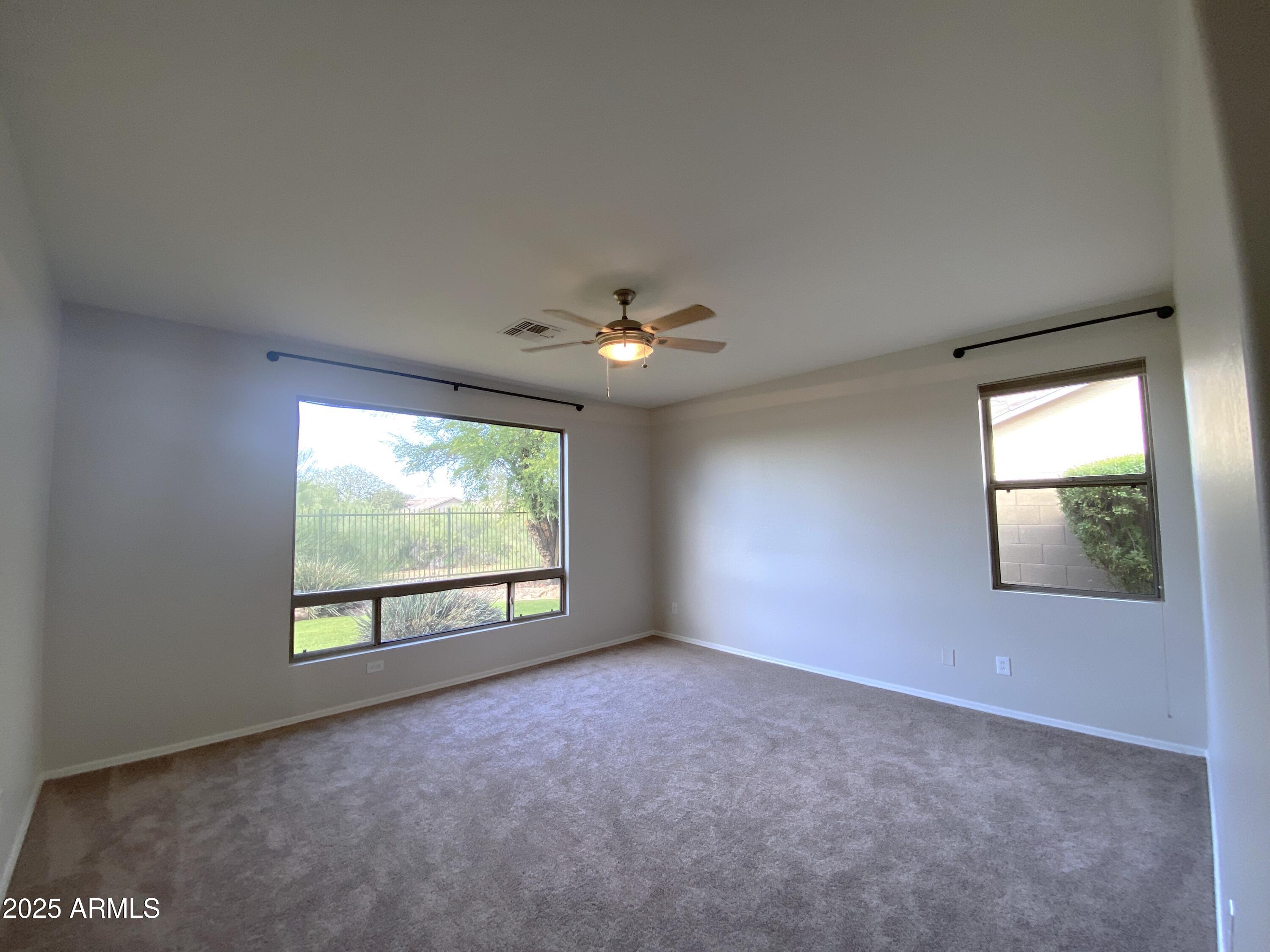 40320 North Exploration Trail Anthem, AZ 85086 - Photo 8 of 33 an empty room with windows and ceiling fan
