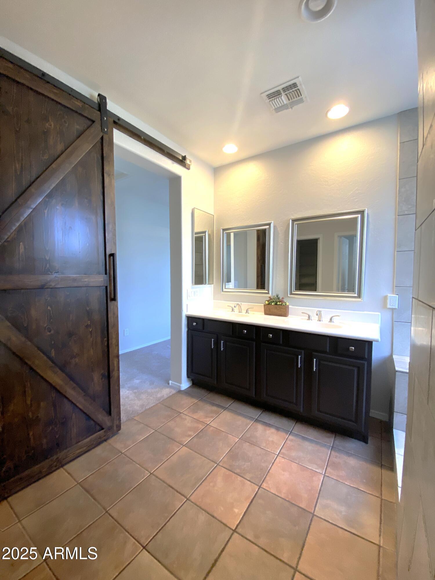 40320 North Exploration Trail Anthem, AZ 85086 - Photo 9 of 33 a spacious bathroom with a double vanity sink and a mirror