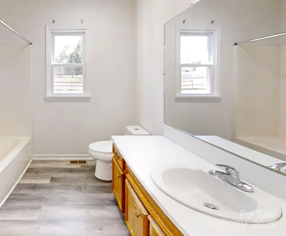 a bathroom with a sink a toilet and tub