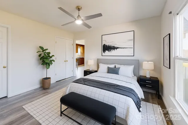 a bedroom with a bed and a potted plant