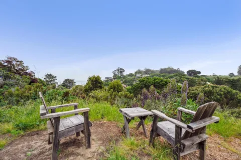 a backyard of a house with table and chairs