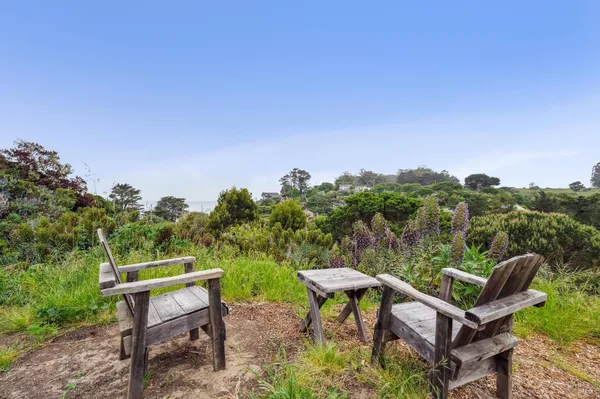 a backyard of a house with table and chairs