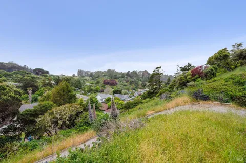 a view of a lake with houses in back