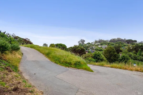 a view of a lake with houses in the back