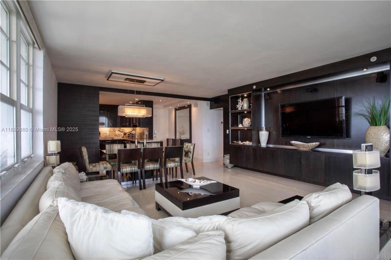 100 Lincoln Road, Unit 647 Miami Beach, FL 33139 - Photo 4 of 10 a living room with furniture and a flat screen tv