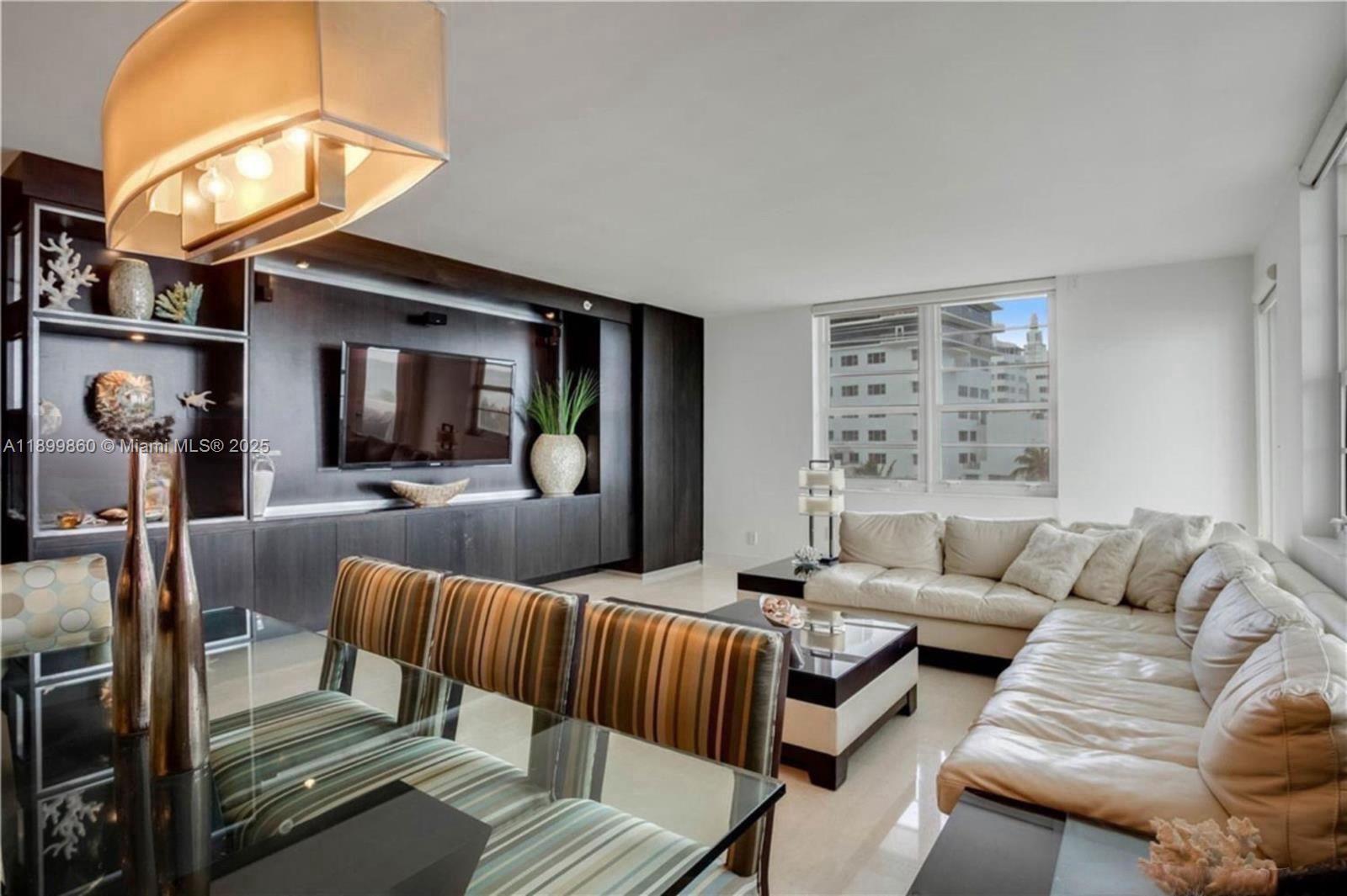 100 Lincoln Road, Unit 647 Miami Beach, FL 33139 - Photo 5 of 10 a living room with furniture and a large mirror