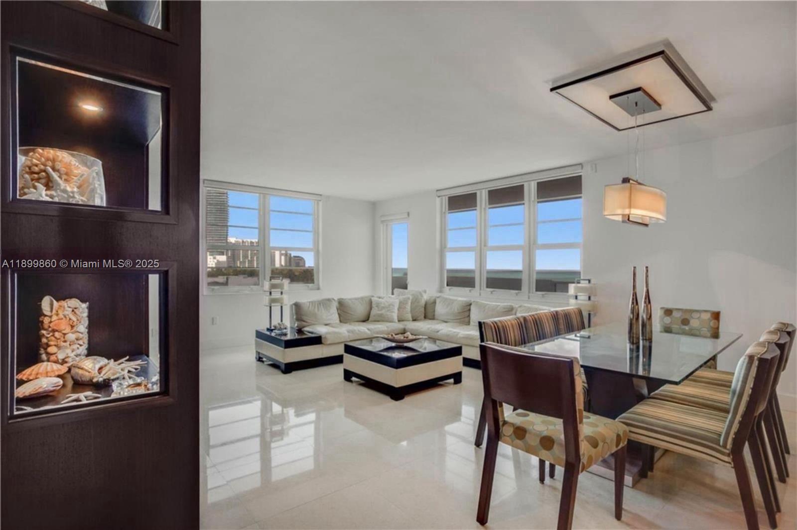 100 Lincoln Road, Unit 647 Miami Beach, FL 33139 - Photo 6 of 10 a living room with furniture and a large window